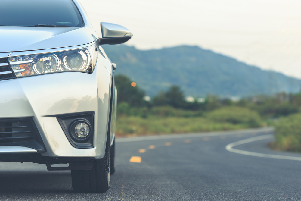 Car on road with mountainous backdrop